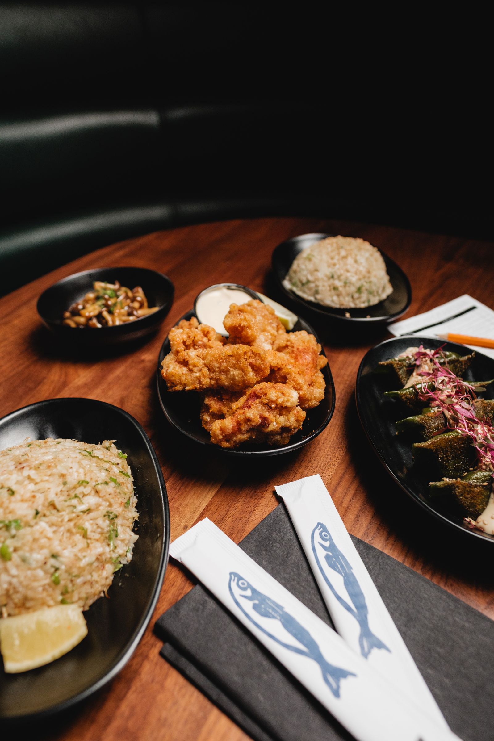 Assorted Asian dishes with fried rice and dumplings on a dark wooden table