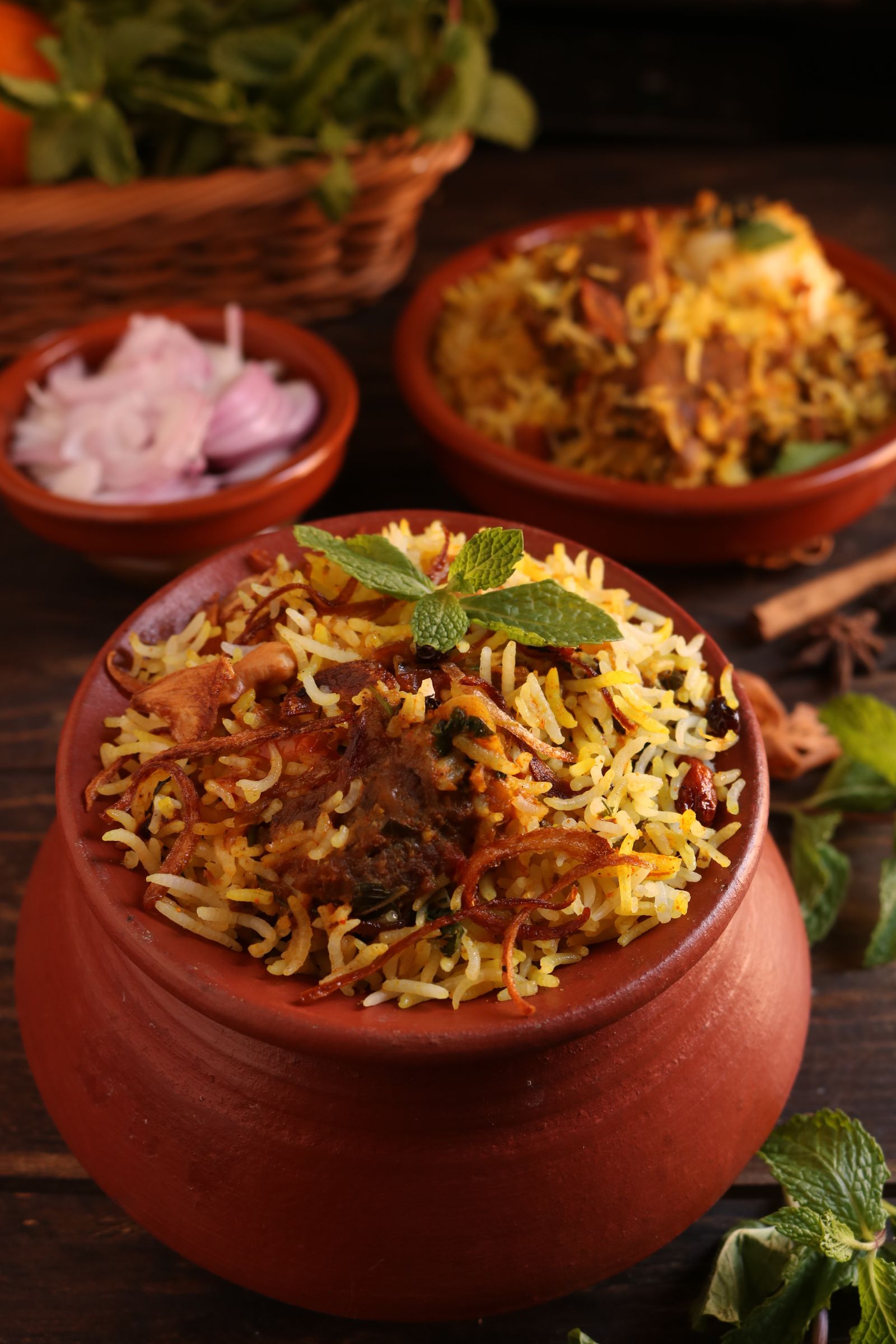 Biryani served in a clay pot with fresh garnish