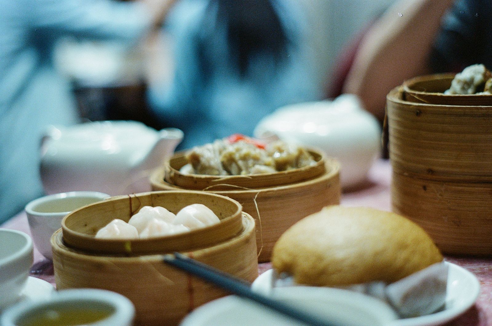 Dim sum served in bamboo steamers with traditional tableware