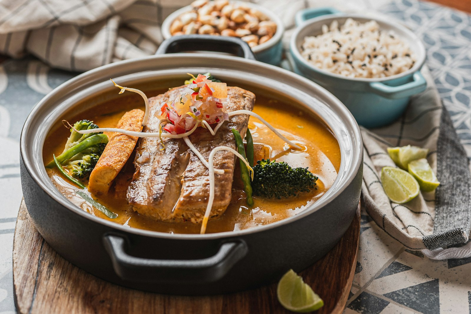Fish curry served with rice, lime and nuts