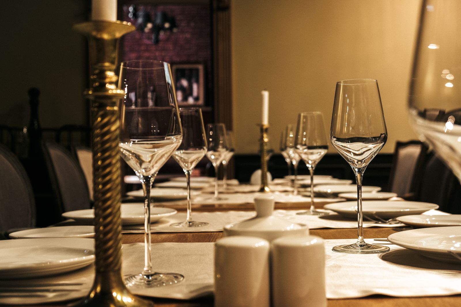 Formal table set with wine glasses and candle holders