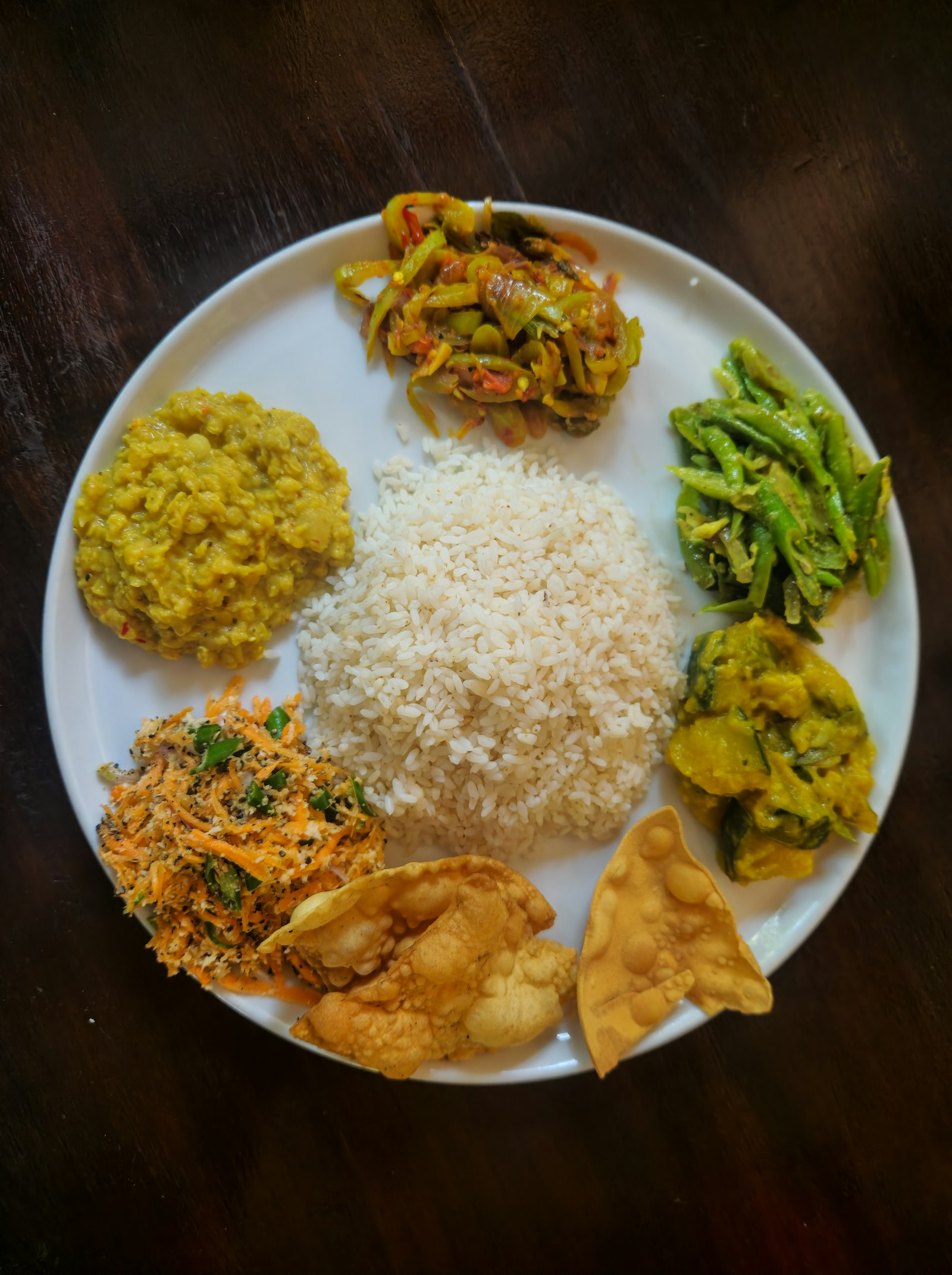 Plate of rice with assorted traditional curries
