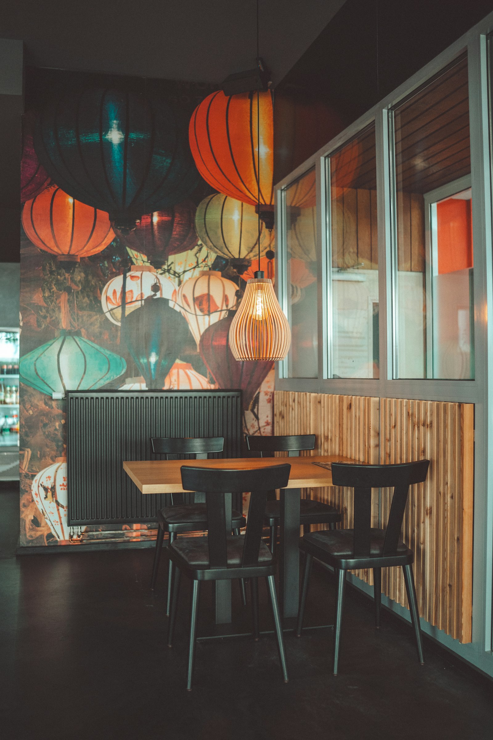 Restaurant corner with lantern wallpaper and set tables