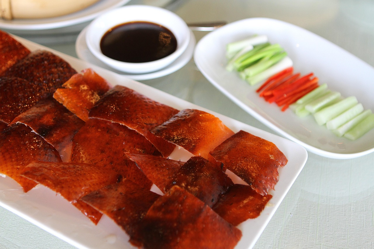 Sliced roast duck with crisp skin served with hoisin and cucumber