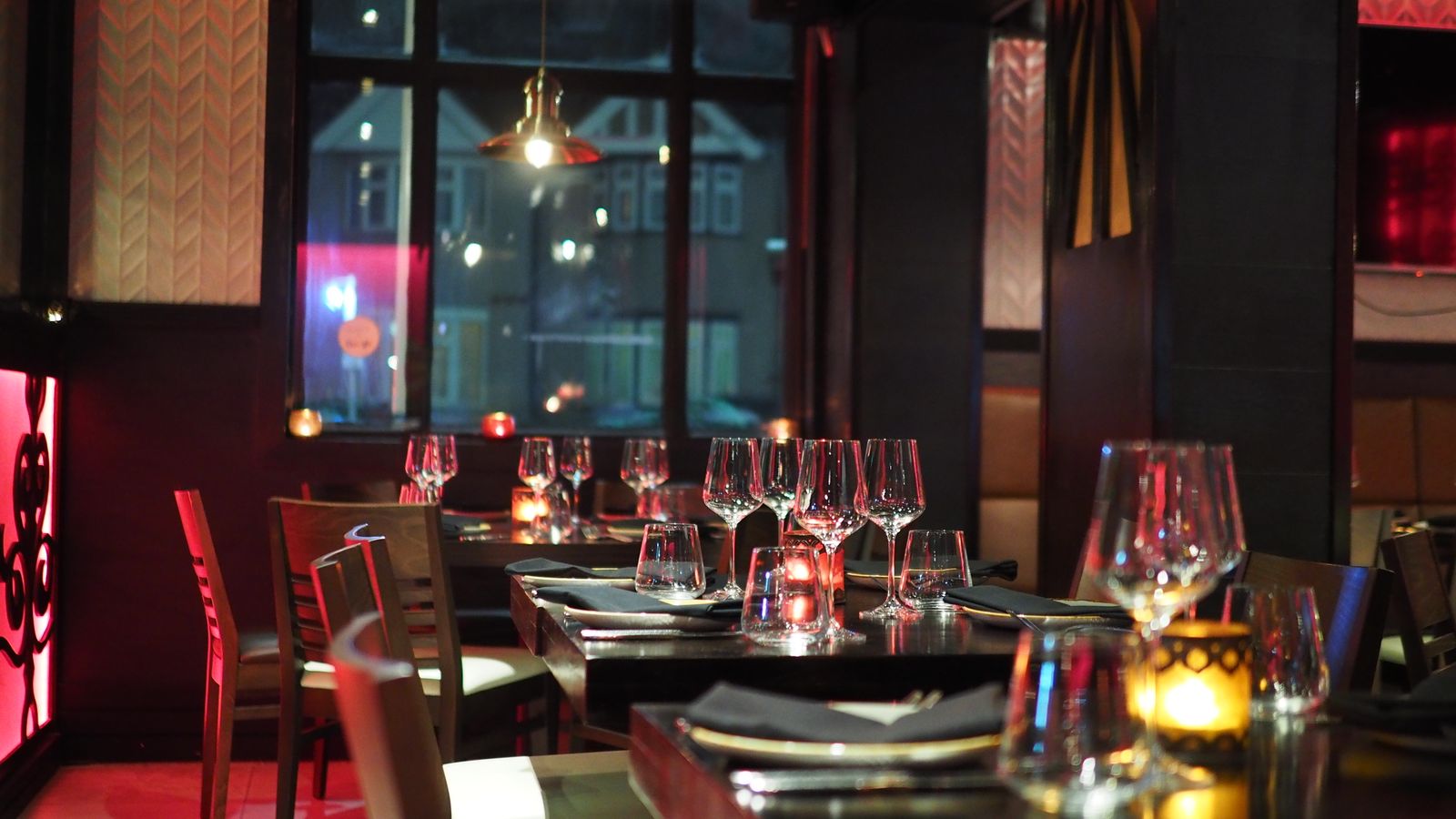 Sophisticated restaurant room with elegant table settings in evening light